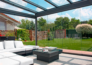 Glass Room with White Wicker Furniture